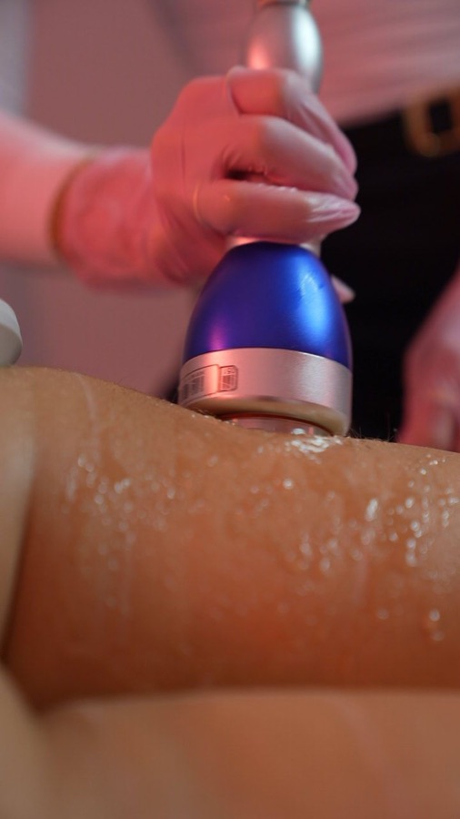Body contouring device mid-treatment in the studio